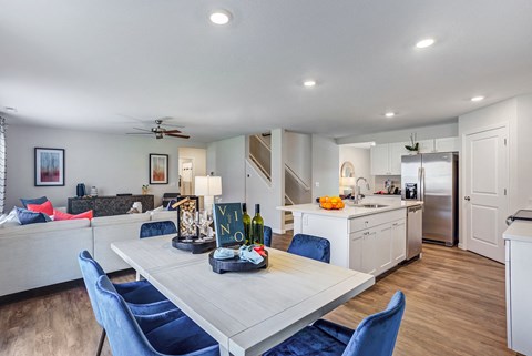 a living room with a kitchen and a dining table